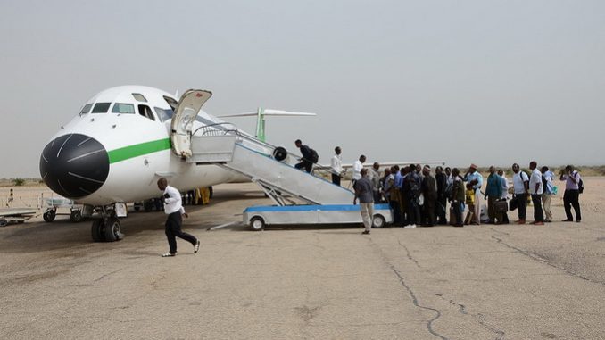 a group of people boarding an airplane