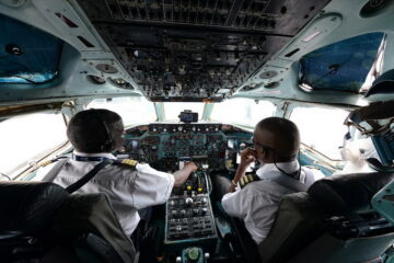 men in the cockpit of an airplane