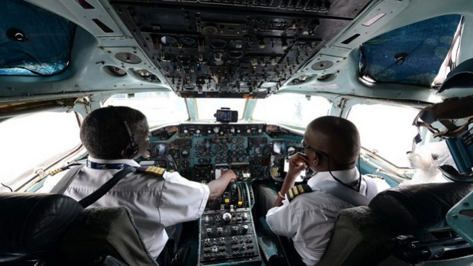 men in the cockpit of an airplane