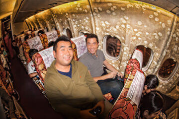a group of men sitting in an airplane