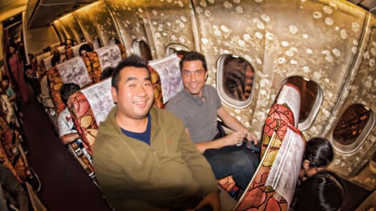 a group of men sitting in an airplane