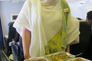 a woman holding trays of food