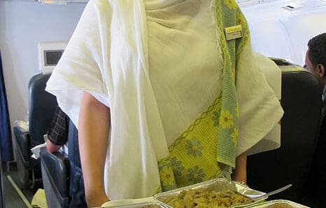 a woman holding trays of food