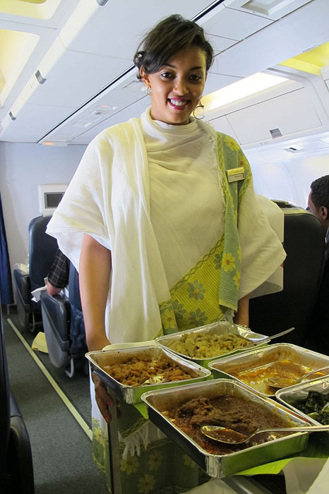 a woman holding trays of food