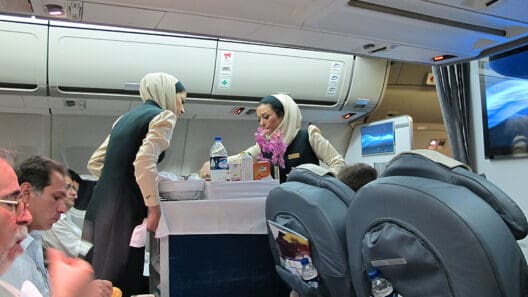 a group of women in uniform standing in an airplane