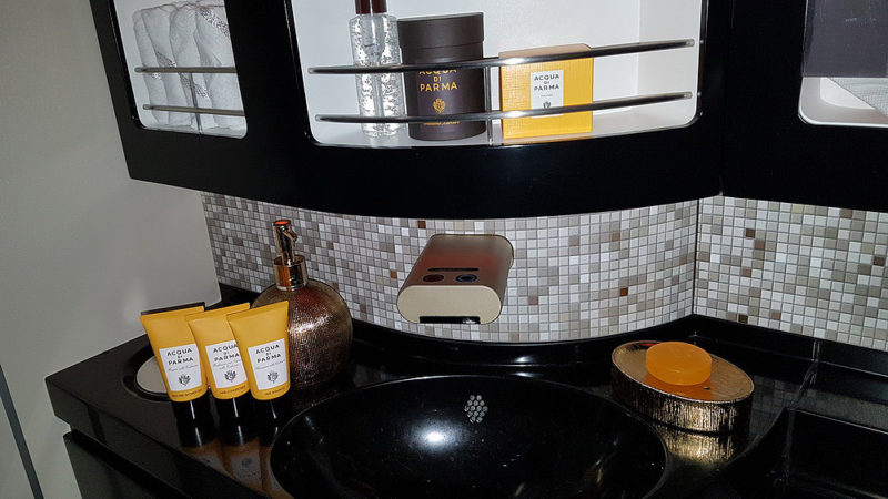 a bathroom sink with a shelf full of products