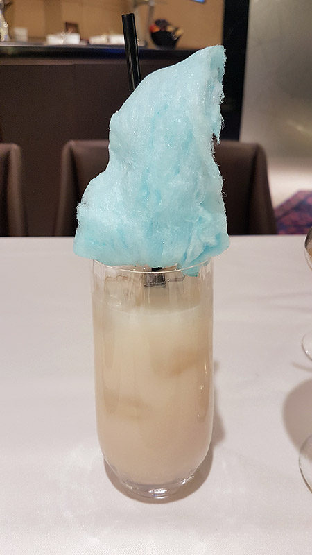 a glass with a blue cotton candy on top