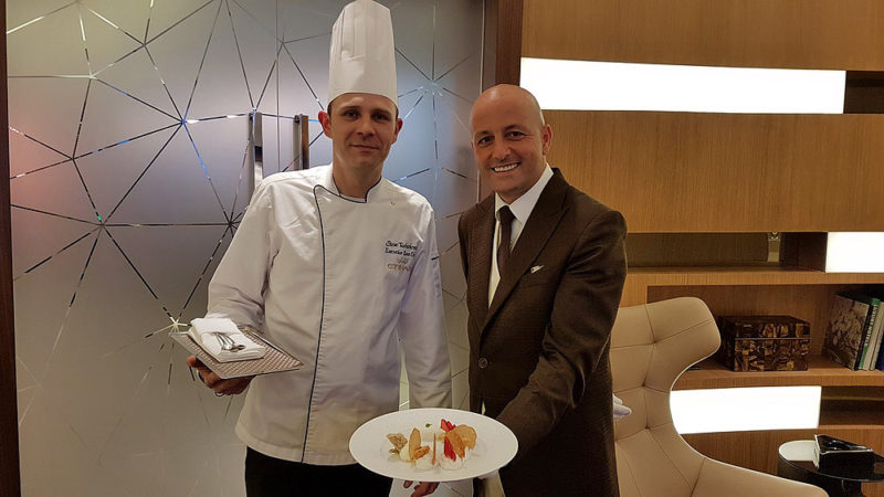 a man in a suit holding a plate of food