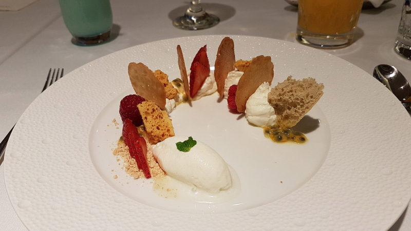a plate of dessert with fruit and ice cream