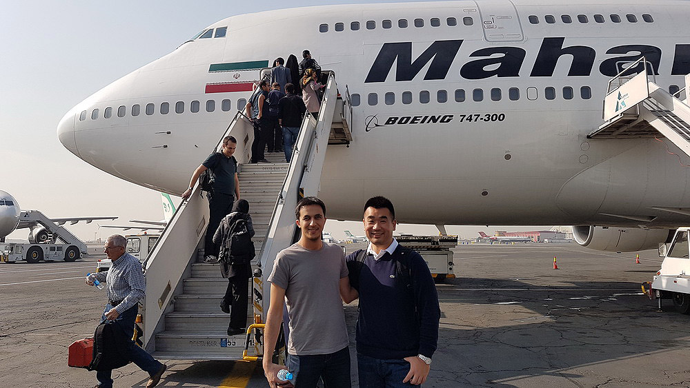 a group of men standing in front of an airplane