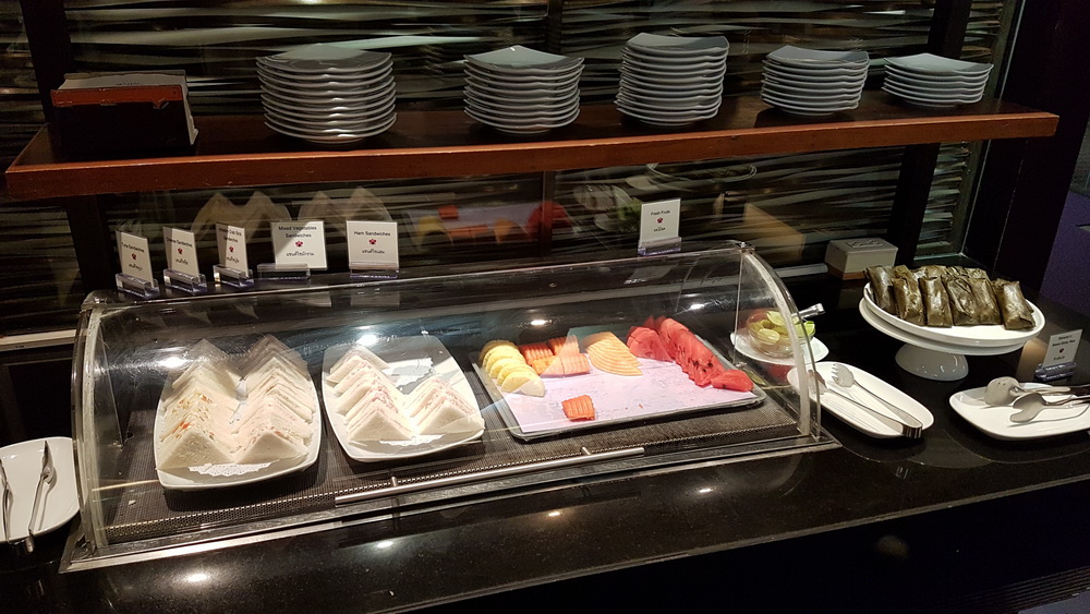 a display case with plates and sandwiches