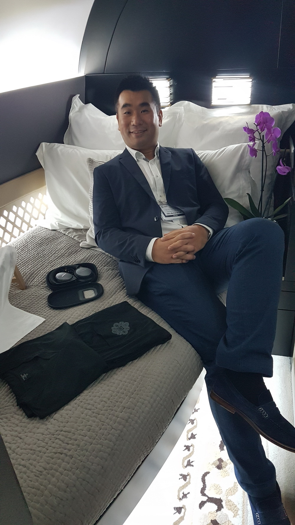 a man in a suit sitting on a bed
