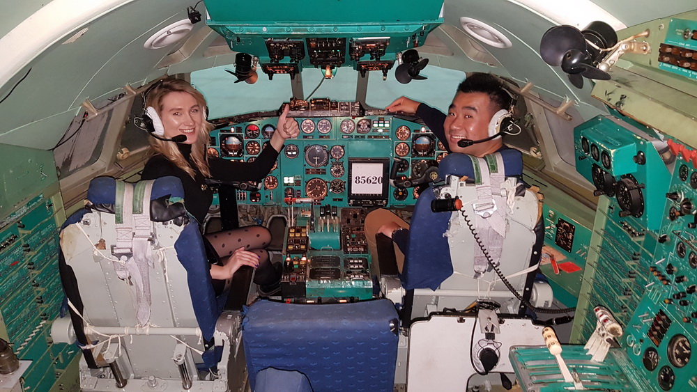 a man and woman in a cockpit of an airplane