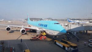 a blue and white airplane at an airport