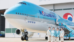 a group of women standing in front of a large airplane