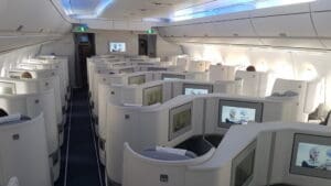 a row of seats with monitors on the side