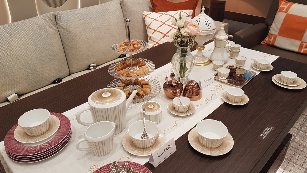 a table with tea cups and teapots