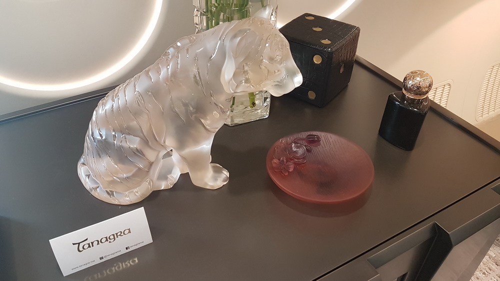 a glass figurine of a tiger on a table