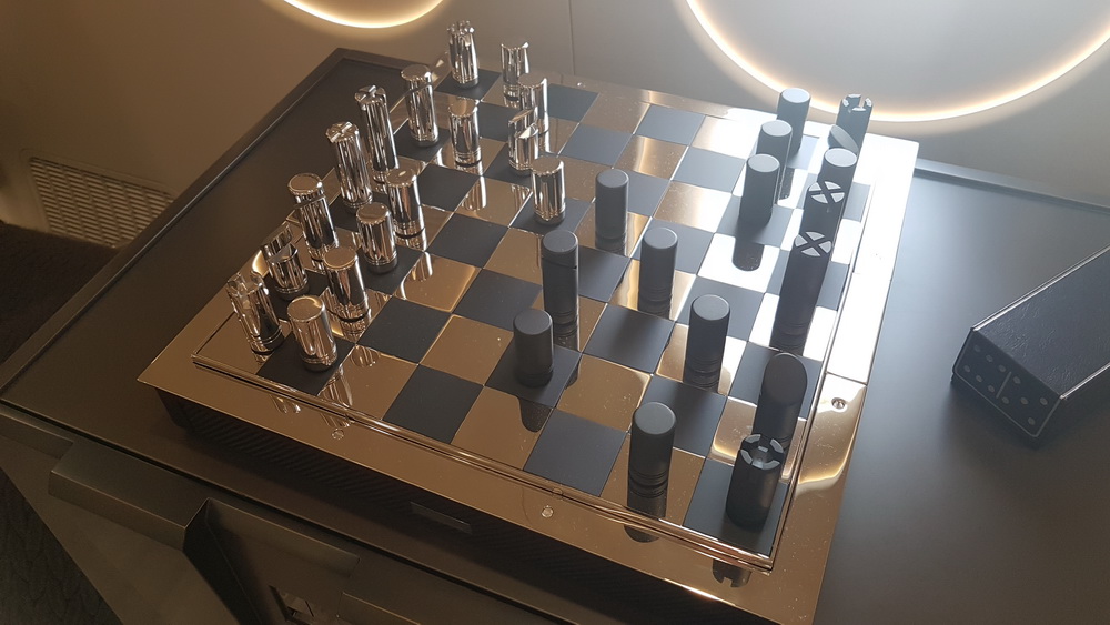 a chess board with a set of metal objects