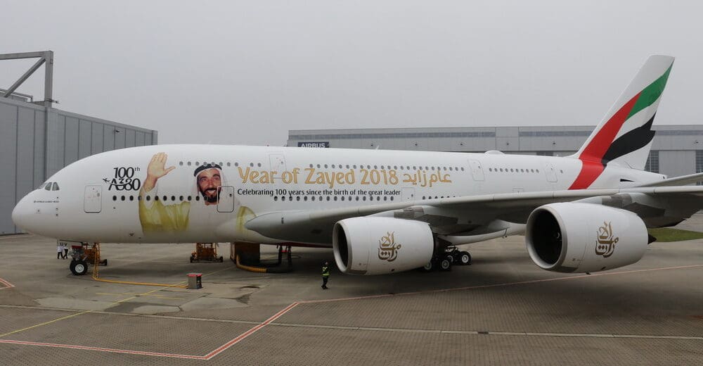 a large white airplane with a cartoon on it