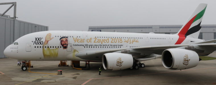 a large white airplane with a cartoon on it