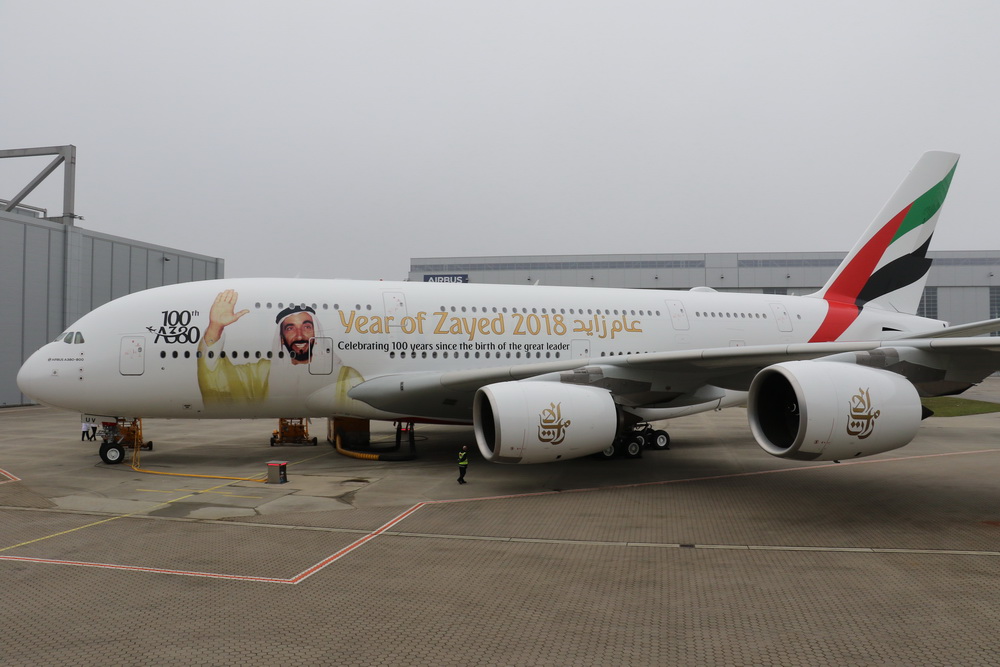 a large white airplane with a cartoon on it