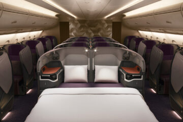 a bed and chairs in a plane