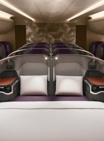 a bed and chairs in a plane