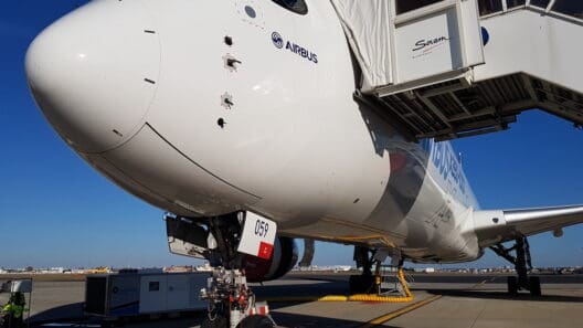 a white airplane with a door open