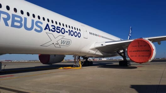 a large white airplane with blue writing on it
