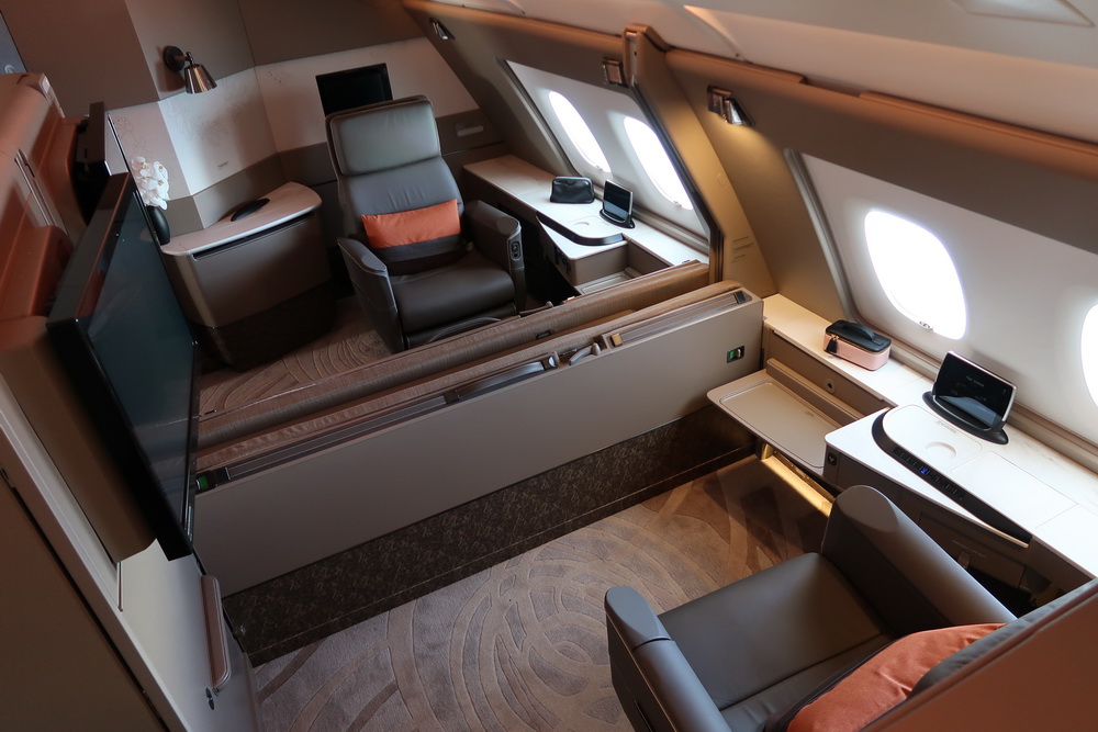 an airplane with a desk and chairs
