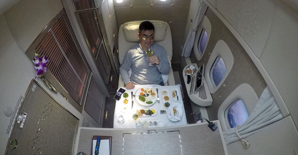 a man sitting in a chair with a glass of wine
