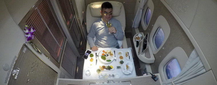 a man sitting in a chair with a glass of wine