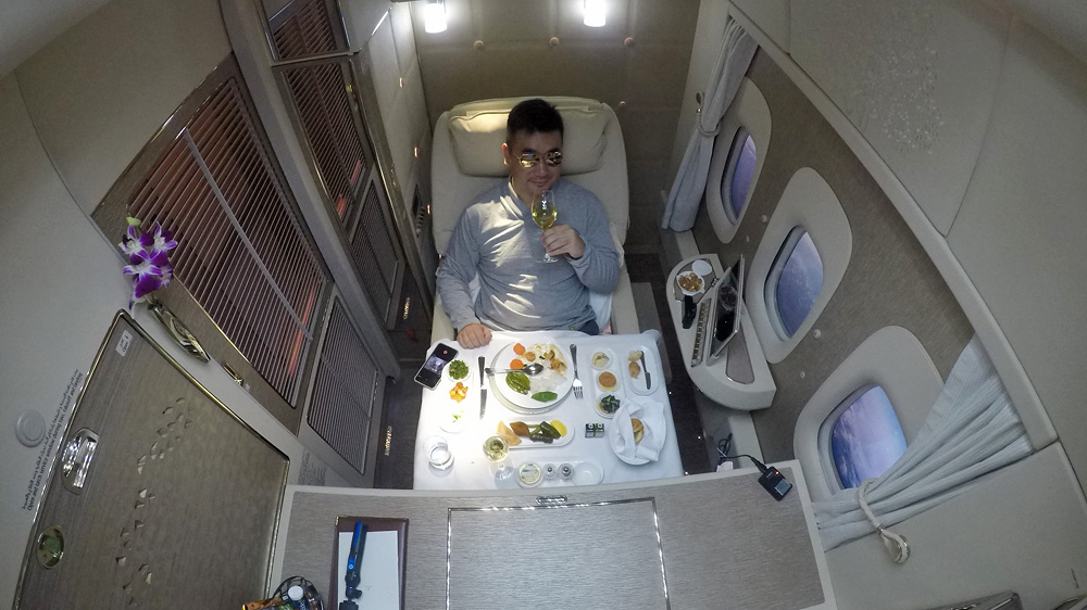 a man sitting in a chair with a glass of wine