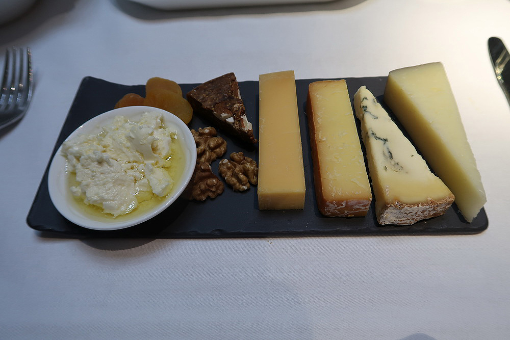 a plate of cheese and nuts