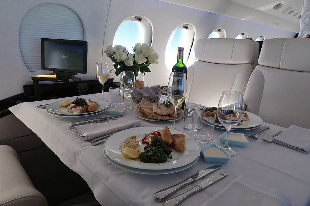 a table with plates of food and wine on it