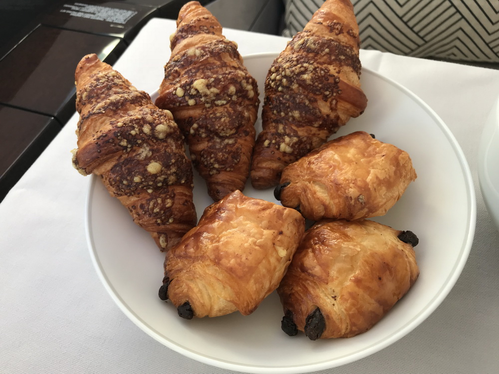 a plate of croissants on a white surface
