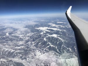 an airplane wing and mountains