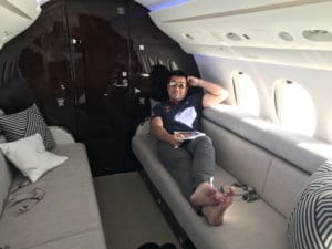 a man sitting on a couch in a plane