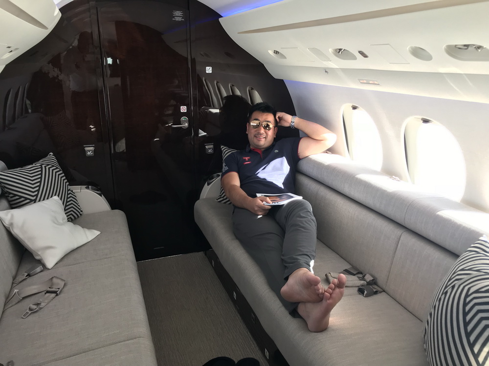 a man sitting on a couch in a plane