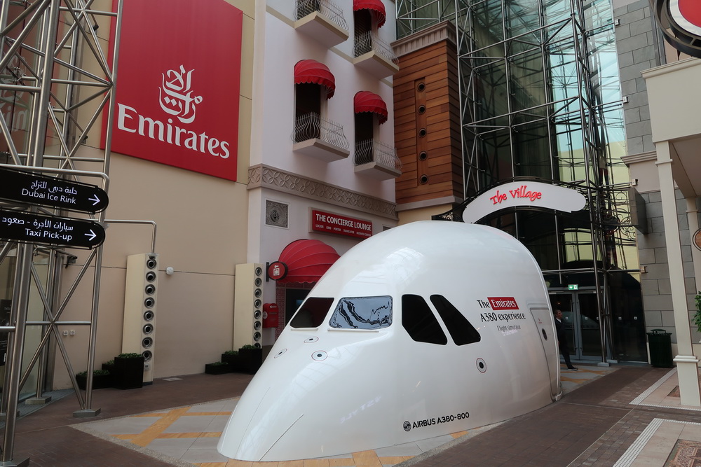 a white airplane shaped object in front of a building