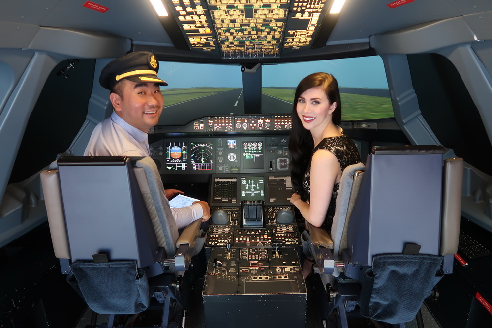 a man and woman sitting in a cockpit of an airplane