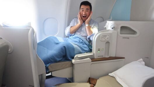 a man sitting in a plane with his hands on his face