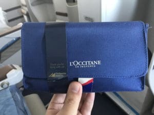 a hand holding a blue wallet