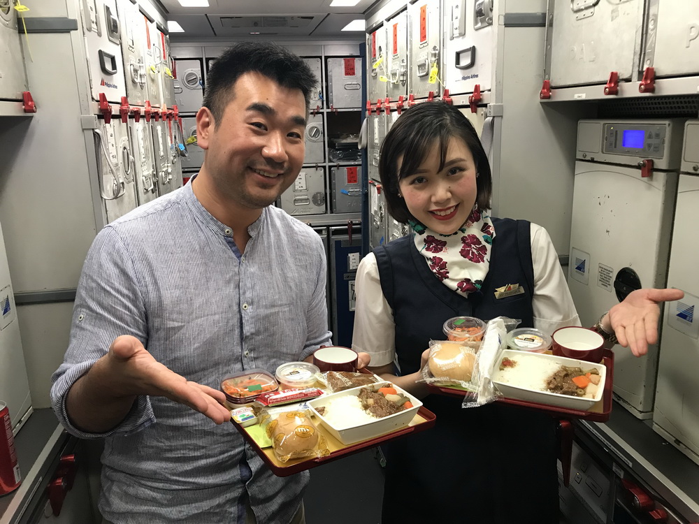 a man and woman holding trays of food