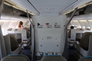 a plane with seats and a woman in the background