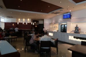 people sitting at tables in a restaurant