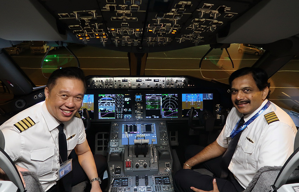 two men sitting in a cockpit