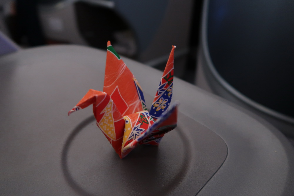 a origami bird on a grey surface