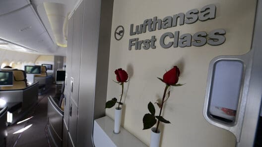 roses in a white vase on a shelf